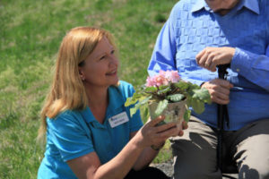 care partner handing flowers to client