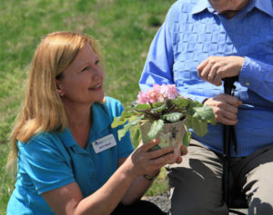 care partner handing flowers to client