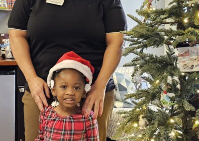 caregiver and child at holiday party